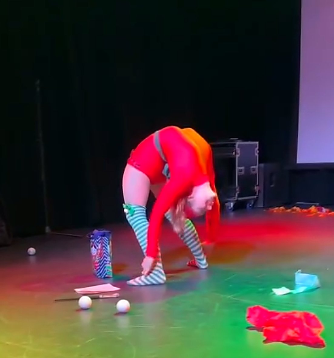 Contortion stage performance under colored lights